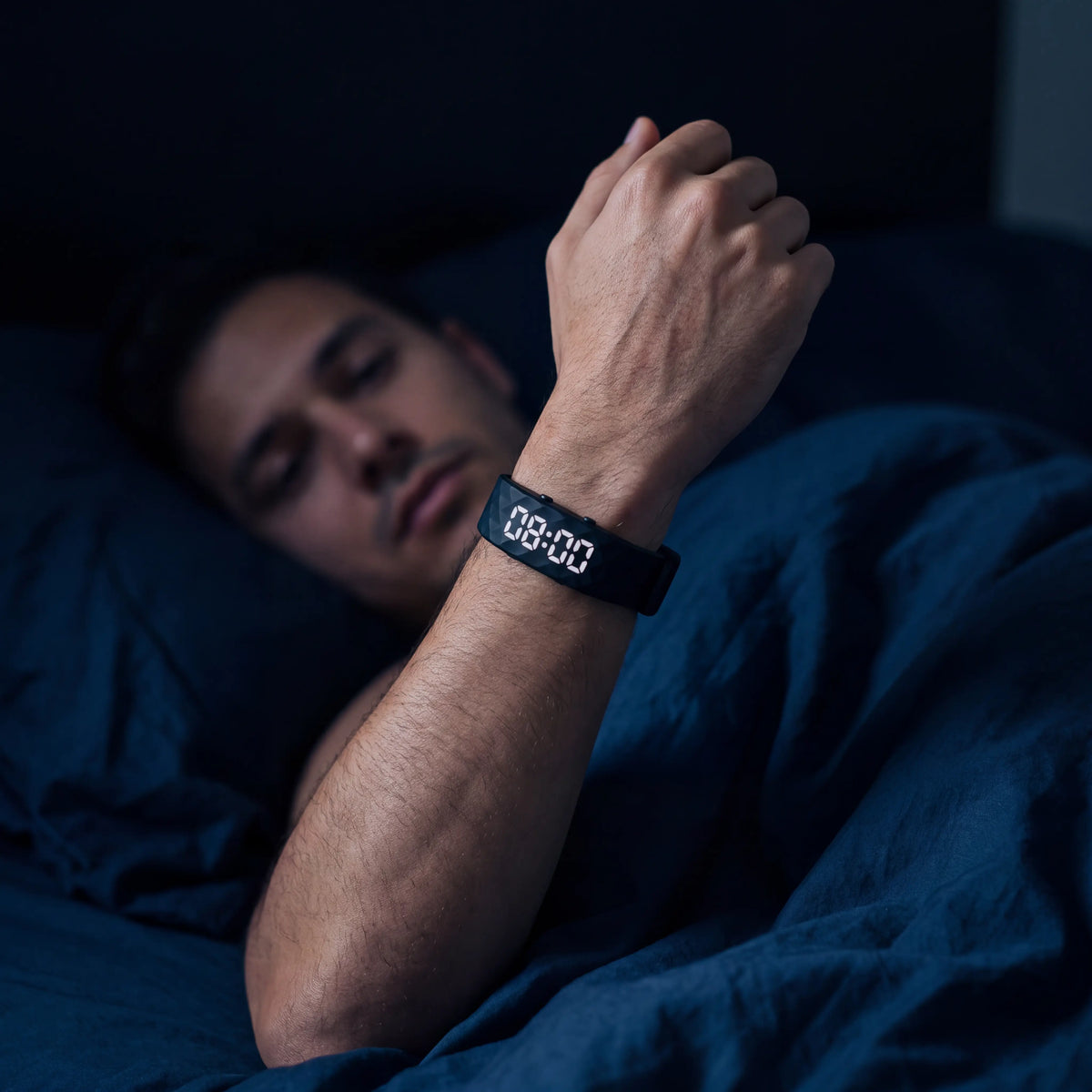 Band display lit up on a raised wrist at night